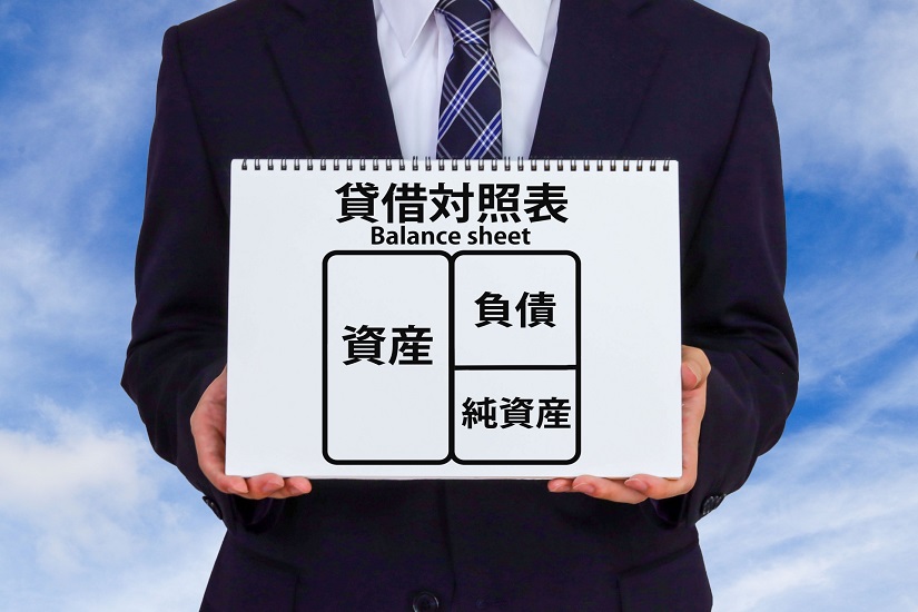 貸借対照表を見せるビジネスマン